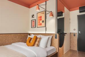 a bedroom with a bed with white pillows at The Usual Brussels in Brussels +49 photos