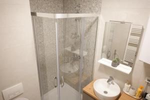 a bathroom with a shower and a sink at Bjelasnica Bliss Apartment in Bjelašnica