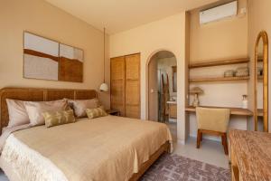 a bedroom with a bed and a table and a chair at Pasir 2 - A stylish 2 bed villa in Bingin w pool in Bingin Beach +37 photos