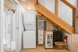 a kitchen with a washer and dryer in a tiny house at Cedar Creek - Glamping in the Ozarks in Walnut Shade +13 photos
