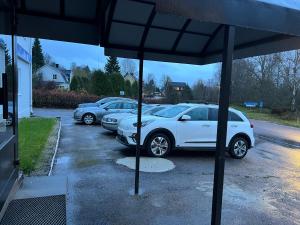 a group of cars parked in a parking lot at Hotel Munkfors in Munkfors