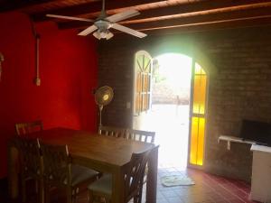 a dining room with a table and a ceiling fan at Complejo Turístico Hugo Ávila in La Rioja