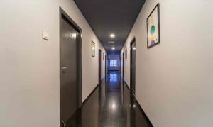 a hallway with white walls and a long hallway at Treebo Skyry Residency in Coimbatore