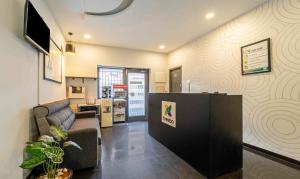 a living room with a couch and a table at Treebo Skyry Residency in Coimbatore