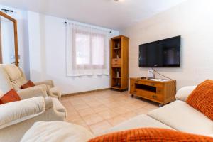 a living room with two couches and a flat screen tv at rentafive - Piscina - Playa - Adosado in Gran Alacant