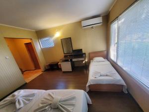 a hospital room with two beds and a piano at Комплекс Хиподрума in Dobrich