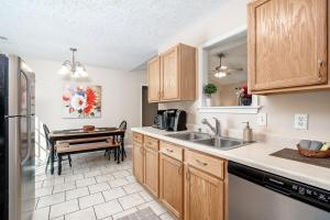 a kitchen with a sink and a table in it at 3BR Home with Smart TVs in Every Room, King Suite & Pool Table in New Bern