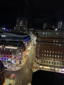 a view of a city street at night at Award Winner of 2026 &2025 traveller & Best guest rated apartment, two bedroom, #1 Leeds city centres most central location, Great 180 degree views,balcony , PARKING onsite, Netflix & WiFi in Leeds