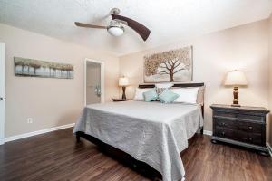 a bedroom with a bed and a ceiling fan at 3BR Home with Smart TVs in Every Room, King Suite & Pool Table in New Bern
