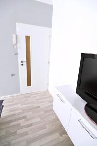 a living room with a television on a white cabinet at AVAX apartment Liberec in Liberec