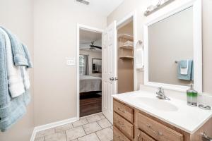 a bathroom with a sink and a mirror at 3BR Home with Smart TVs in Every Room, King Suite & Pool Table in New Bern +30 photos