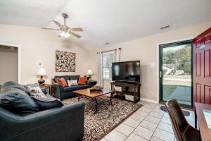 a living room with a couch and a tv at 3BR Home with Smart TVs in Every Room, King Suite & Pool Table in New Bern