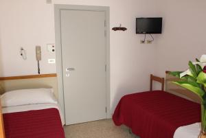 a room with a bedroom with a bed and a tv at Hotel Emma in Cattolica