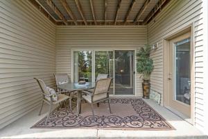 a patio with a table and chairs on a porch at Blue Heron Hideaway - Table Rock Lake in Branson