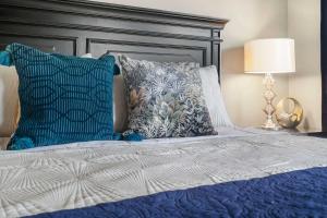 a bedroom with a bed with blue and white pillows at Blue Heron Hideaway - Table Rock Lake in Branson