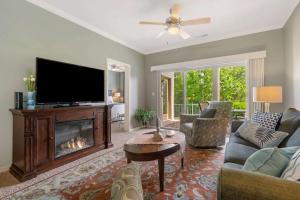 a living room with a fireplace and a flat screen tv at Blue Heron Hideaway - Table Rock Lake in Branson