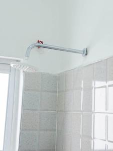 a shower curtain in a bathroom with a window at the cozy lookout in Malindi