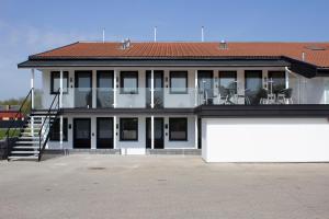 a large white building with chairs on the balcony at A Hotels Roskilde in Hedehusene