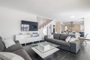 アデへにあるBEAUTIFUL VILLA - 4 bedrooms, heated pool, 2 priv car park places, fibre net, PS5, tv channelsのソファとテーブルのあるリビングルーム