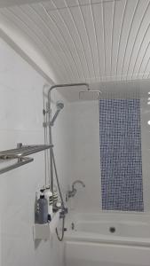 a bathroom with a bath tub with a shower curtain at 연 스테이 in Seoul