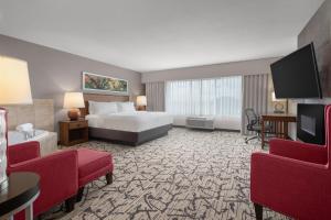 a hotel room with a bed and a flat screen tv at Holiday Inn Stevens Point - Convention Center by IHG in Stevens Point