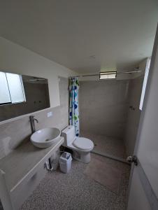 a bathroom with a toilet and a sink and a mirror at TUMI Villa Salkantay in Colcapampa +41 photos