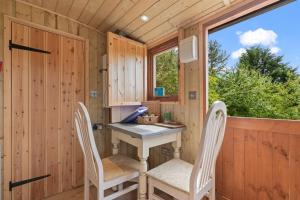 YarpoleにあるOff-Grid Glamping - Quiet, Starry Escapeの小さな家のテーブルと椅子2脚