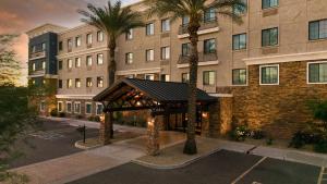 a gazebo in front of a building with palm trees at Staybridge Suites Chandler by IHG in Chandler