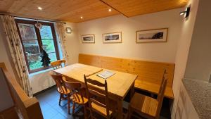 a dining room with a wooden table and chairs at Ourson in Grimentz