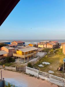 a group of houses on the beach next to the ocean at Casa de Praia Tribo de Judá in Bragança