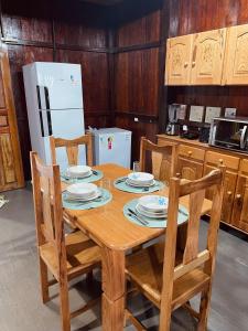 a kitchen with a wooden table with plates on it at Casa de Praia Tribo de Judá in Bragança