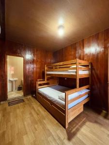 two bunk beds in a room with wooden walls at Casa de Praia Tribo de Judá in Bragança +42 photos
