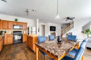 a kitchen with a dining table and blue chairs at Fabulous & Stylish 4BR w Pool Table and Space to Chill in Houston