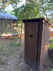 a wooden out house with a heart on it at Jurta na Souvrati 