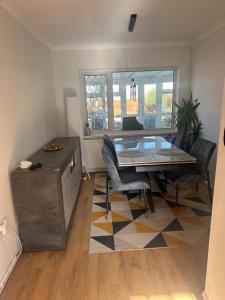 a living room with a dining room table and chairs at Newport by M4 in Newport