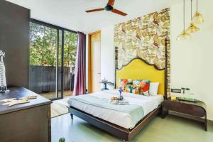 a bedroom with a large bed and a large window at Villa Kosha - Lux 3BR Villa wPrivate Pool Siolim in Siolim +30 photos