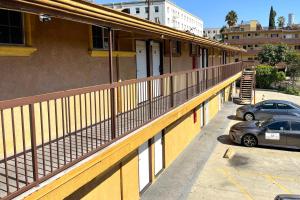 a parking lot with cars parked on the side of a building at Travel Inn Downtown LA in Los Angeles +13 photos
