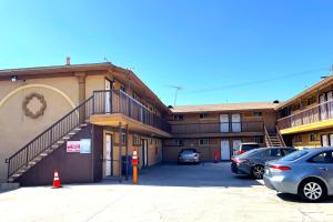 a large building with cars parked in a parking lot at Travel Inn Downtown LA in Los Angeles