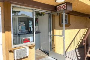 an office sign on the side of a building at Travel Inn Downtown LA in Los Angeles