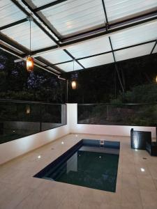 a swimming pool in a patio with a roof at Manawa Kaona in Somondoco