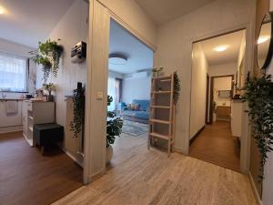 a hallway with a living room and a kitchen with plants at Central Menton Near Monaco in Menton