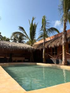a resort with a swimming pool and palm trees at Casa Antonio Mazunte in Mazunte