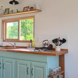 a kitchen counter with a sink and a window at Cabaña entre molles in Punta Indio