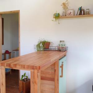 a wooden table in a room with a shelf at Cabaña entre molles in Punta Indio