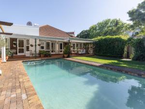 a swimming pool in the backyard of a house at Villa Puccini in Cape Town