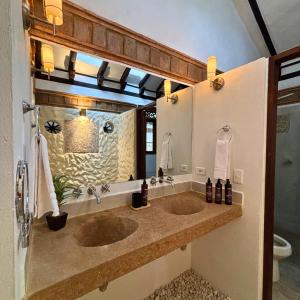 a bathroom with two sinks and a large mirror at Hacienda Cascanueces in Villa de Leyva