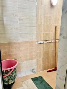a bathroom with a bucket and a wall at Dar Lala Fatima Zahrae in Rabat