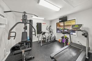 a gym with three tread machines and a treadmill at Midnight Cove II 117F in Siesta Key
