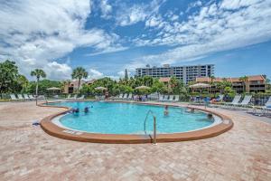 a swimming pool in a resort with people in it at Midnight Cove II 111F in Siesta Key