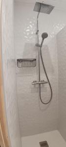 a shower with a shower head in a bathroom at Notre Dame de Monts Entre mer et marais in Notre-Dame-de-Monts